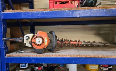 a chainsaw that is sitting on a shelf in a garage