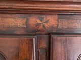 a close up of a wooden cabinet with a clock on it