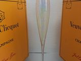 a champagne glass sitting next to a box of champagne