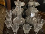 bottles and glasses on display in front of a mirror in a room