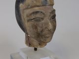 a statue of a woman ' s head on a clear stand