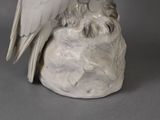 porcelain figurine of a white bird perched on a rock