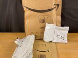 a brown bag with a smile on it sitting on a table next to a brown bag with a smile on it