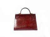 an image of a brown leather handbag on a white background