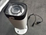 a camera that is sitting on the ground next to a wall