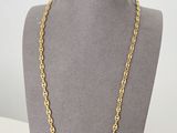 a gold chain necklace on a mannequin mannequin display