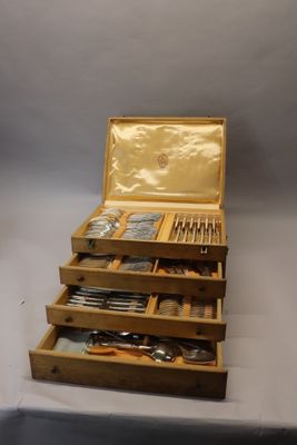 a wooden box with silverware in it on a table