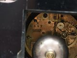 a close up of a clock with a metal ball inside of it