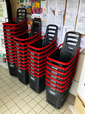 many black and red baskets lined up on the floor
