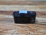 a small camera sitting on a wooden table