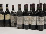 several bottles of wine are lined up on a white surface