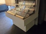 a glass display case in the middle of a room