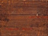 an old wooden box that has writing on it