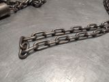 a metal chain with a lock attached to it on a table