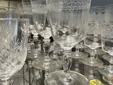 many wine glasses sitting on a table in a room