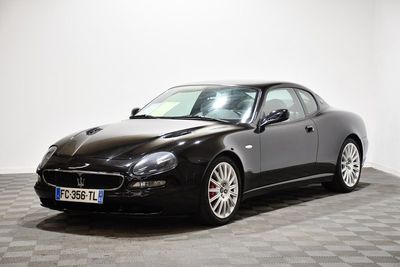 an image of a black mas car on a checkered floor
