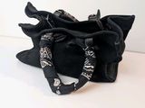 a small black bag with a bow on it