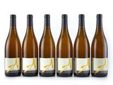 six bottles of white wine lined up in a row