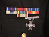 a military uniform with a medal and a ribbon on it