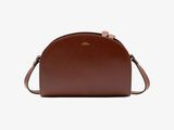 a brown leather cross body bag on a white background