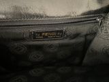 a close up of a purse with a tag on it