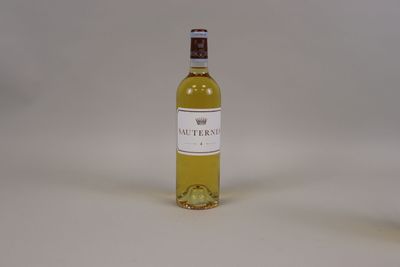 a bottle of wine sitting on a table next to a glass of wine