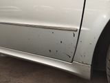 a white car that has been damaged and is parked in a lot