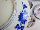 a blue and white plate with a blue flower on it