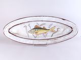 une image représentant une assiette sur laquelle est peint un poisson
