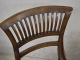 a wooden chair that has a wooden seat on it