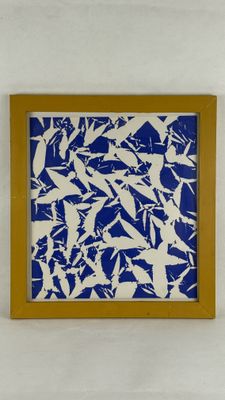 blue and white painting of birds in a wooden frame on a white wall