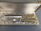 a silver case with a knife, fork and knife set in it