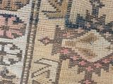 close up of a rug with a cat sitting on top of it