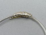 silver bang bracelet with a lizard on it ' s back