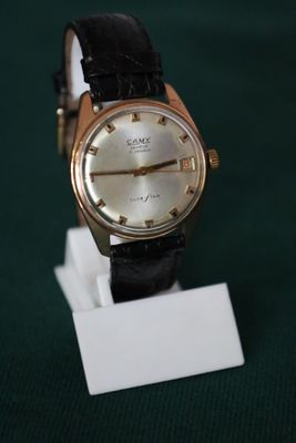 a watch that is sitting on a stand on a table