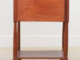 a small wooden table with a drawer on top of it