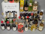 many different bottles of alcohol on the table