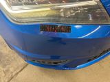 a close up of a car ' s headlight with a sticker on it