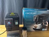 an image of a coffee maker sitting on top of a wooden table