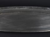 a silver tray on a black table with a black background
