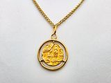 a gold necklace with a gold coin on a white mannequin