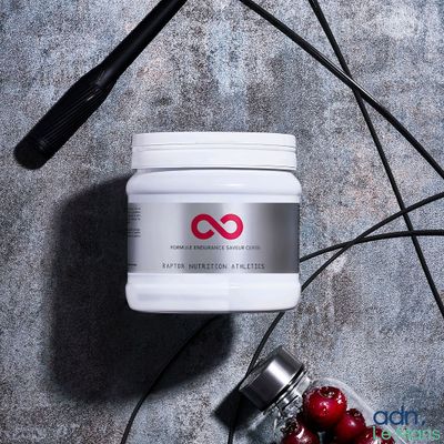 a jar of cherries and a hair dryer on a table