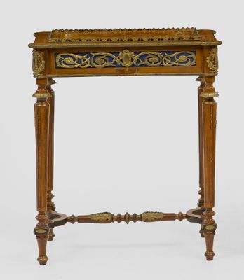 an old wooden table with a blue and gold design on the top