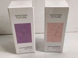 two boxes of perfume sitting next to each other on a table