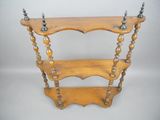 an antique wooden shelf with three shelves on each side of it