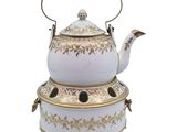 a white tea pot with a gold decoration on it