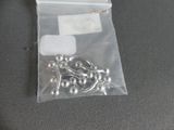 a bag of silver beads and a pair of scissors on a table