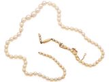 a close up of a necklace with pearls on a white background