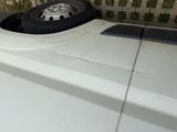 a tire that is sitting on the side of a white car