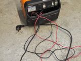 an orange and black radio sitting on the ground